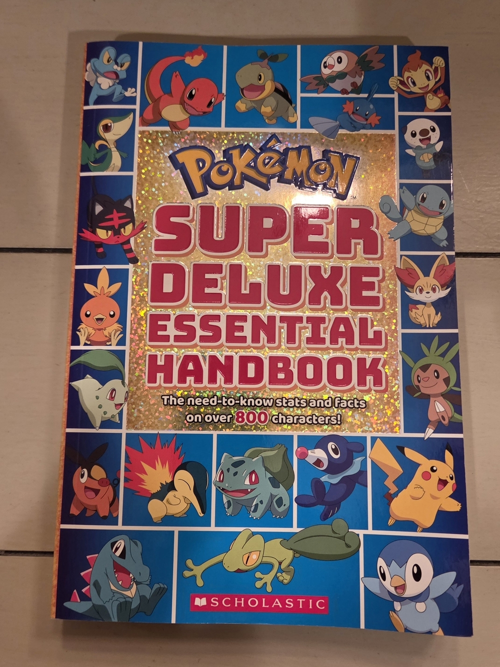 "Pokémon - Super Deluxe Essential Handbook"  - Paperback - By Scholastic